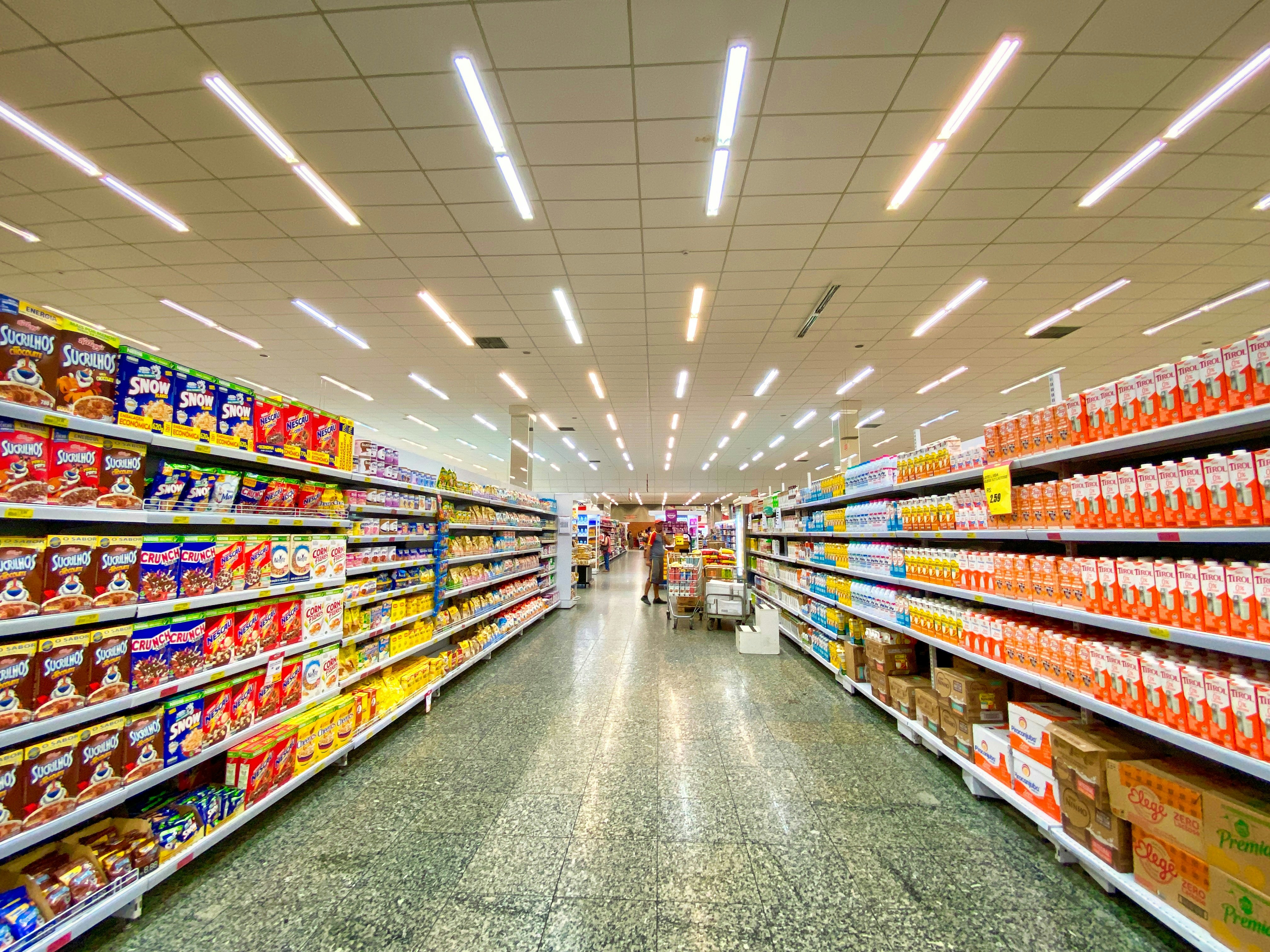 Modern retail supermarket with organized product shelves and customer operations environment