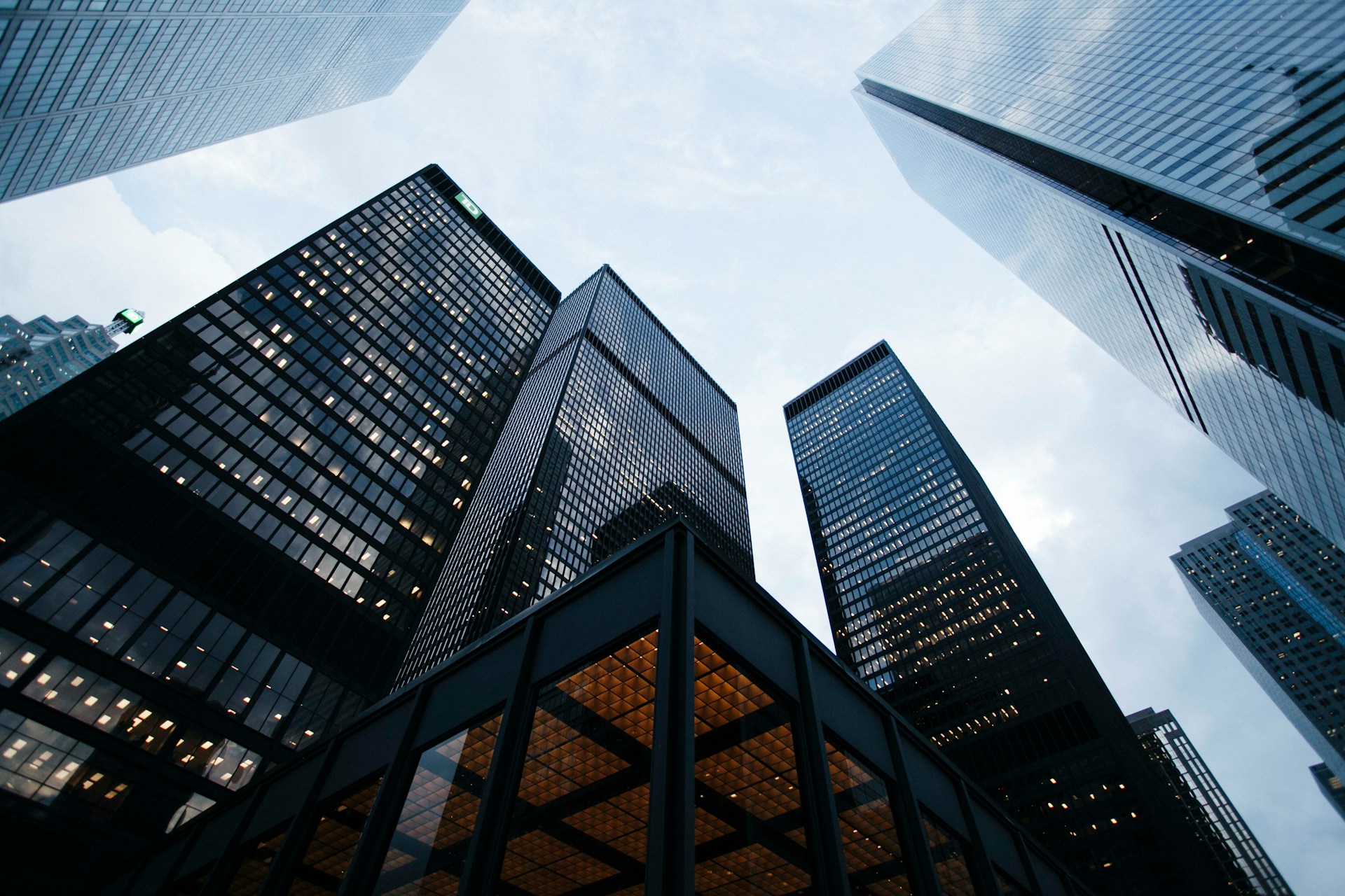 Glass skyscrapers rising against a blue sky in a financial district